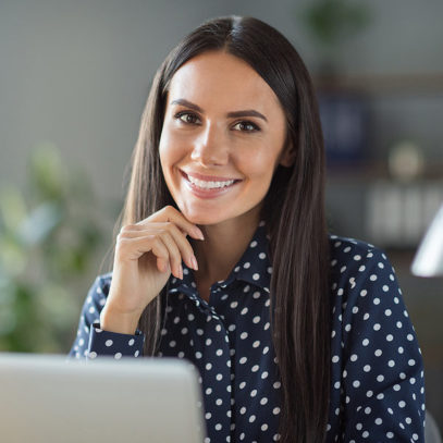 brunette haired business woman using laptop